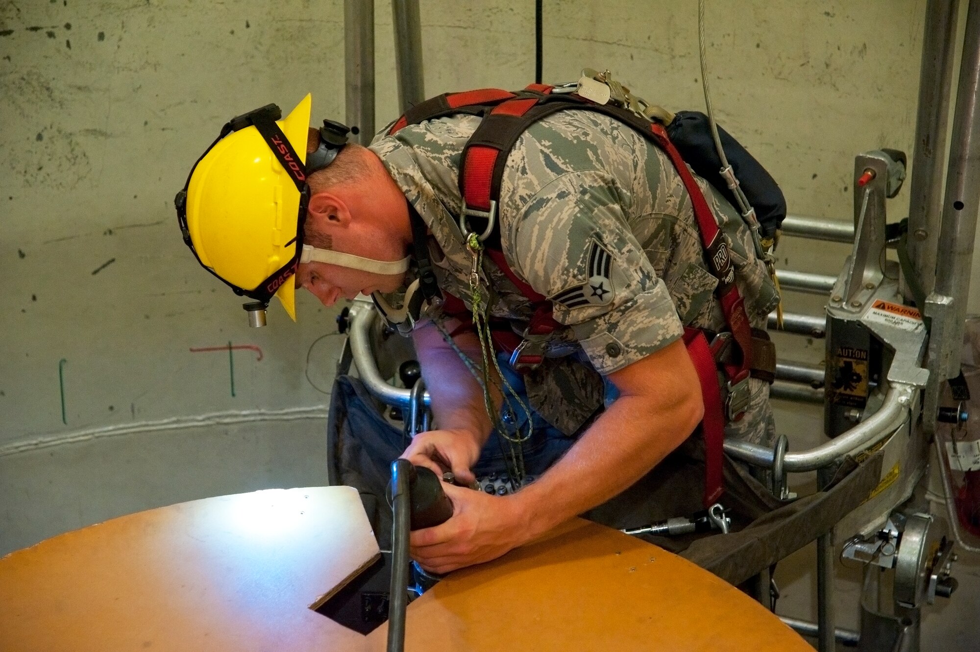 Senior Airman Samuel Leisy, 341st Maintenance Operations Squadron boardman, connects a hazardous current test cable to the downstage of a missile system at Malmstrom’s T-41 trainer Aug. 11. During the competition, Leisy will work with his fellow teammates to provide support and maintenance to the lower components of the competition’s training missile system.  (U.S. Air Force photo/Airman 1st Class Collin Schmidt)