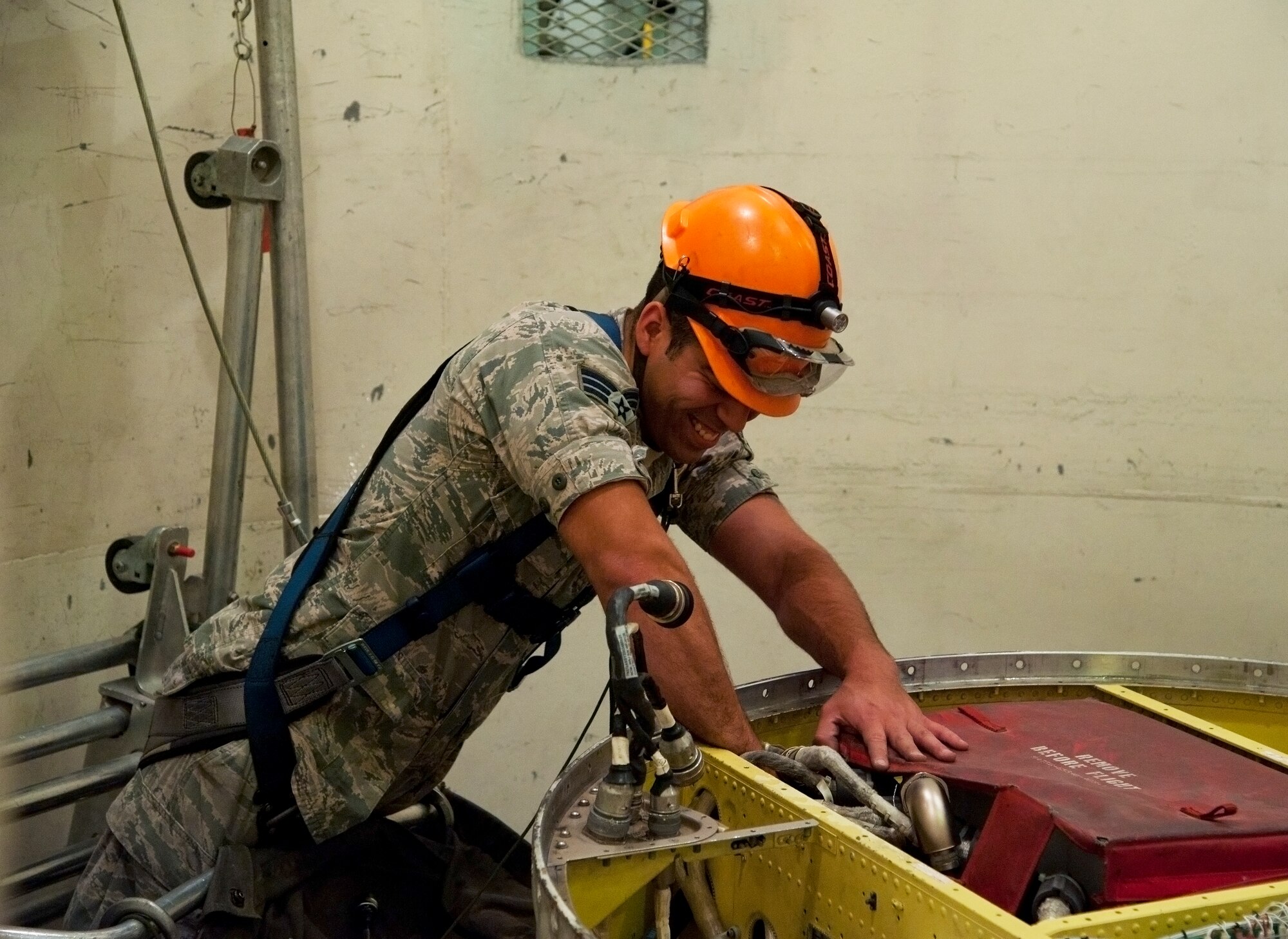 Senior Airman Shawn Castellanos, 341st Missile Maintenance Squadron cage man, disconnects a set of missile guidance cables during a training session at Malmstrom’s T-41 trainer Aug. 11. During the competition, Castellanos will be suspended in a maintenance cage, which circles around the missile, and will perform maintenance on the lower half of the missile system. (U.S. Air Force photo/Airman 1st Class Collin Schmidt)