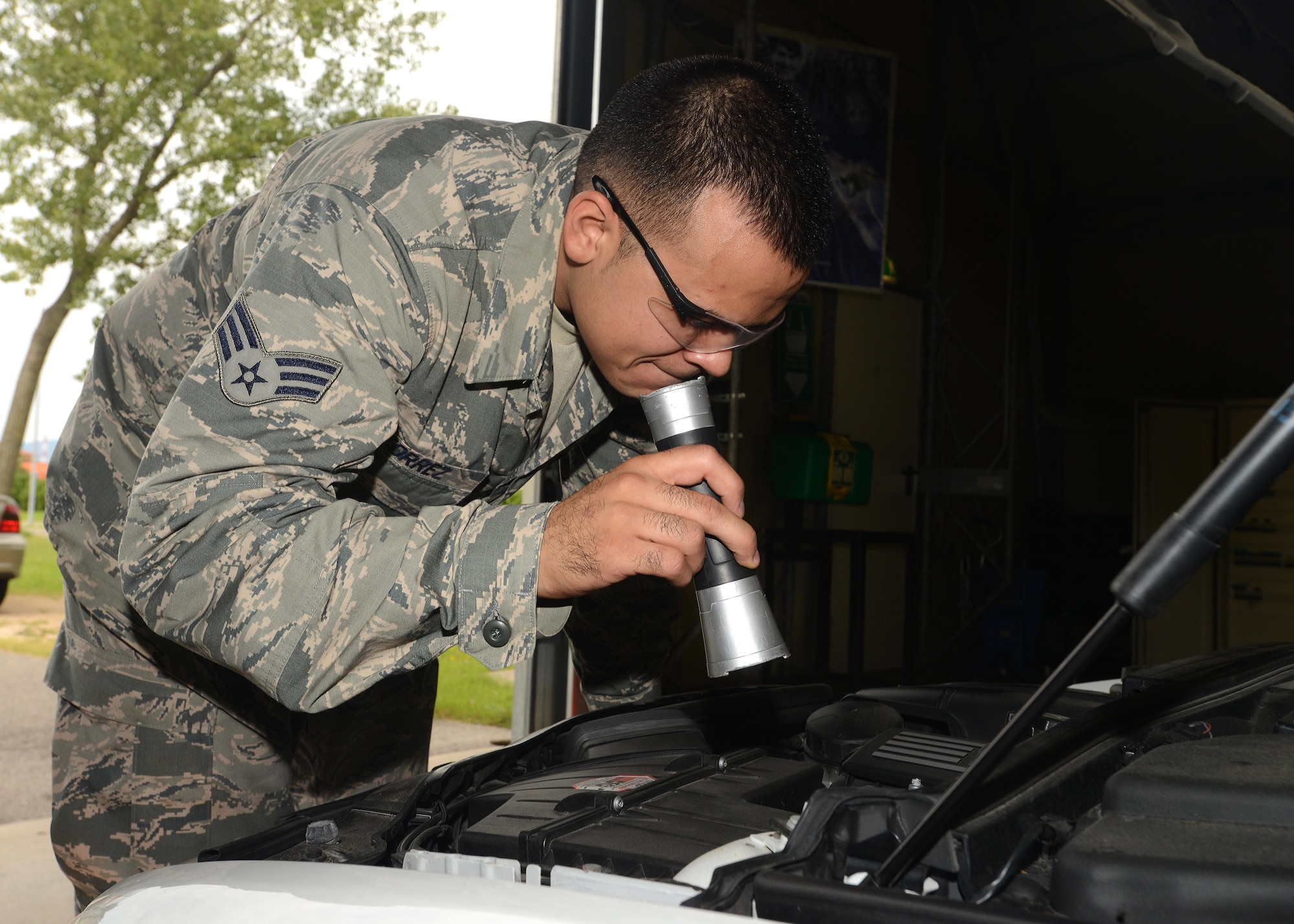 Senior Airman Adrian Torrez, 31st Logistics Readiness Squadron vehicle maintenance craftsman, inspects a vehicle during a privately owned vehicle inspection, Aug. 18, 2014, at Aviano Air Base, Italy. In addition to POV inspections, the vehicle inspection tent is now a satellite location for vehicle registration renewals for Team Aviano members. (U.S. Air Force photo/Airman 1st Class Deana Heitzman)  