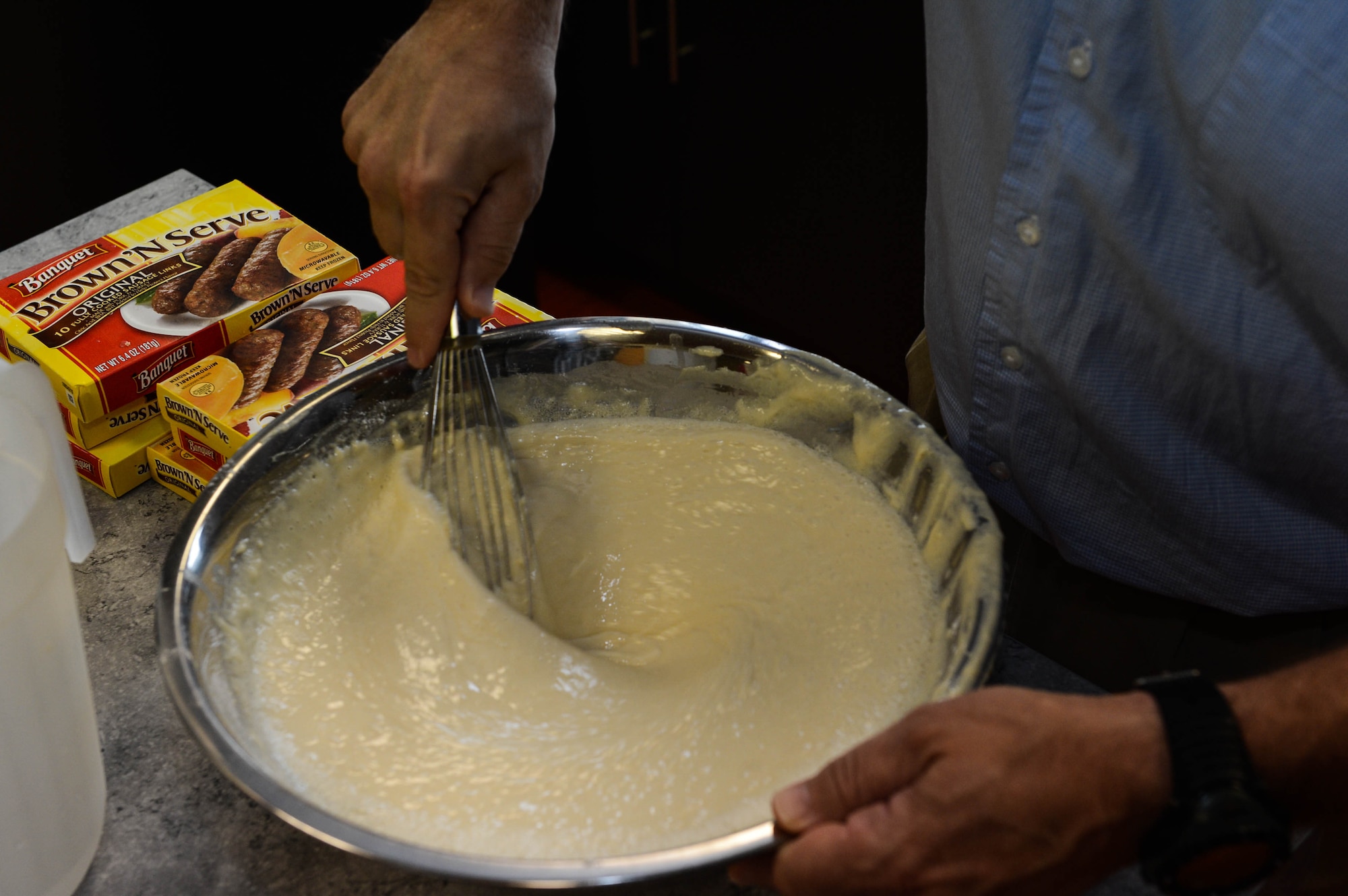 U.S. Air Force Col. Robert Winkler, 52nd Operations Group commander, mixes pancake batter for a community breakfast in the chapel at Spangdahlem Air Base, Germany, Aug. 17, 2014. The Spangdahlem Catholic community hosted the breakfast for families after a religious service. The complimentary meal fed more than 80 people. The chapel provides services for a variety of religious backgrounds. (U.S. Air Force photo by Airman 1st Class Kyle Gese/Released)