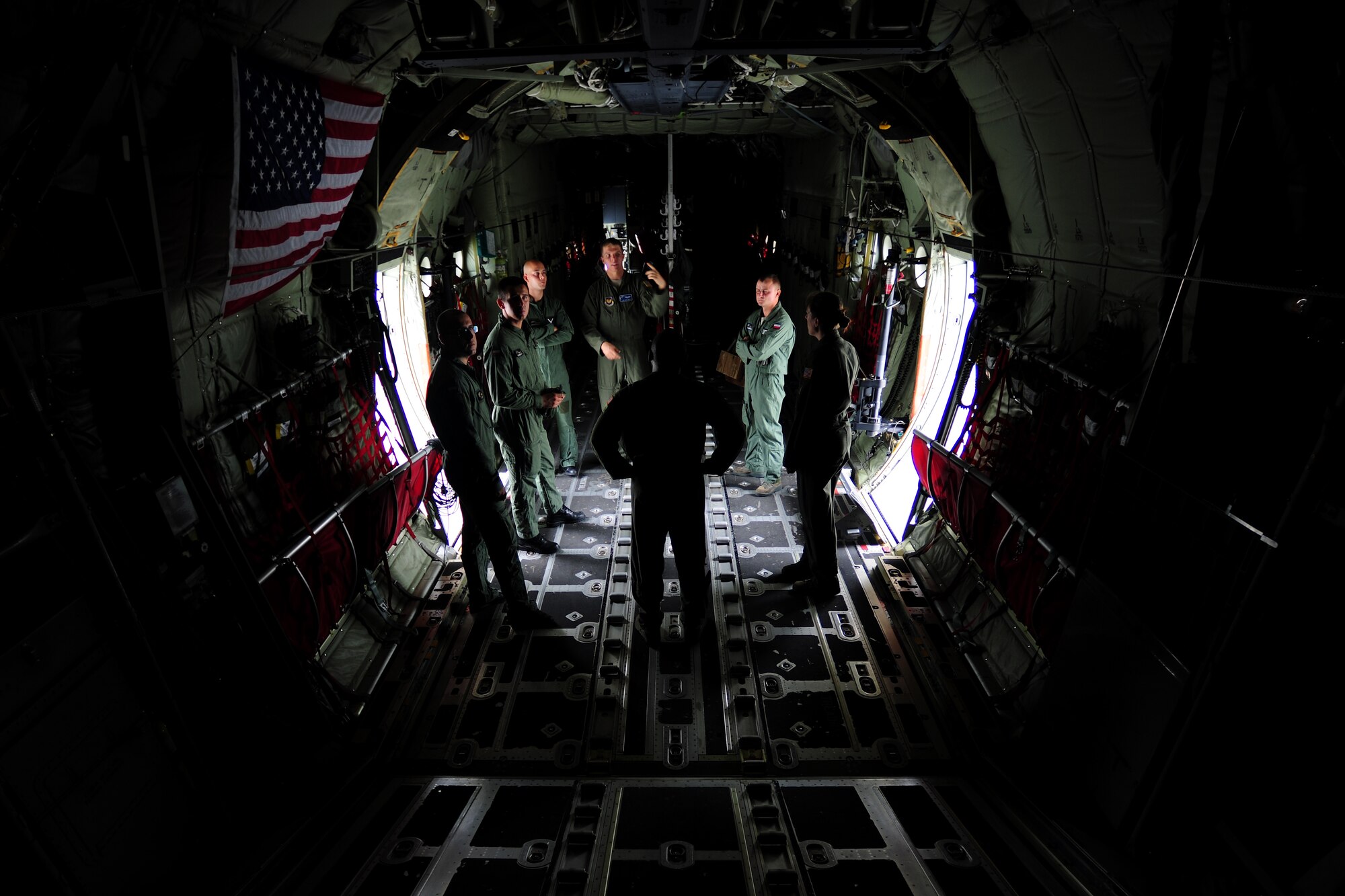 U.S. and Polish Air Force loadmasters discuss mass container delivery airdrop operations aboard a C-130J Super Hercules at Powidz Air Base, Poland, Aug. 11, 2014. Airmen from both nations discussed operational similarities and best practices in preparation for Poland to conduct an equipment and supply mission to Iraq. (U.S. Air Force photo by Staff Sgt. Jarad A. Denton/Released)