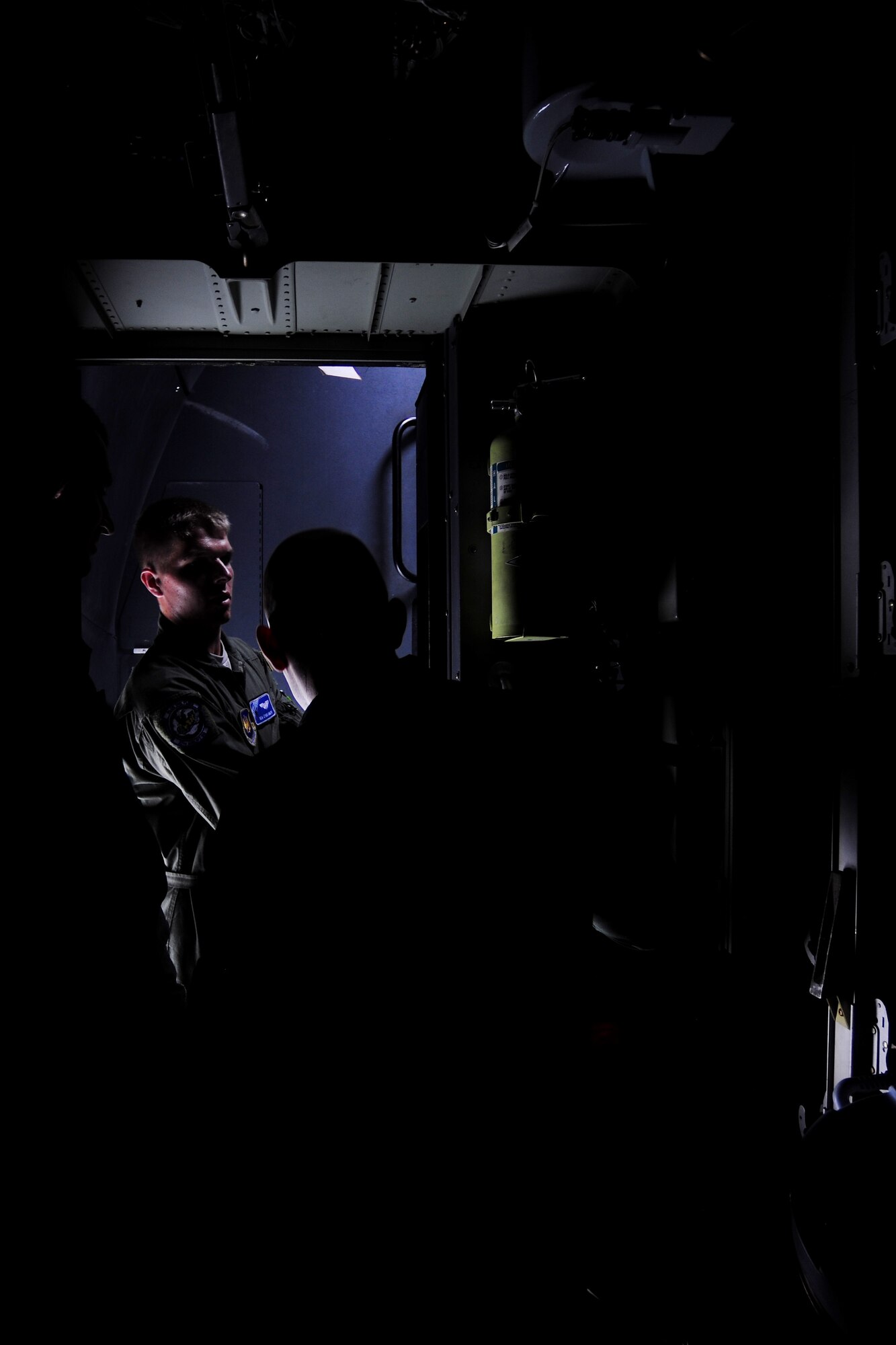 U.S. Air Force Senior Airman Chris Rolph, 37th Airlift Squadron loadmaster, left, reviews the cargo capabilities of the C-130J Super Hercules during a bilateral training with Polish Air Force loadmasters at Powidz Air Base, Poland, Aug. 11, 2014. The joint training allowed Polish Air Force Service members to hone their skills in preparation for humanitarian missions to Iraq. (U.S. Air Force photo by Staff Sgt. Jarad A. Denton/Released)