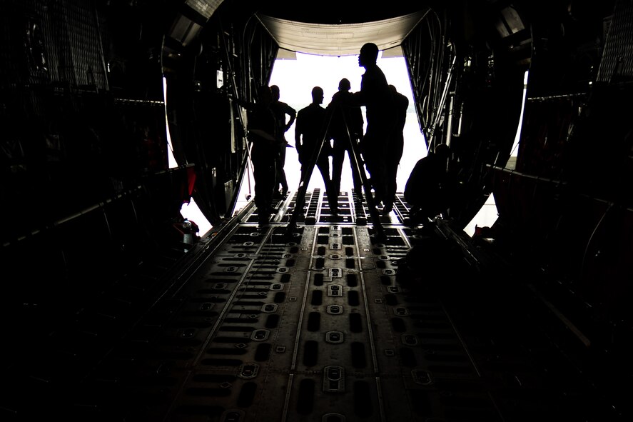U.S. Air Force Master Sgt. Chris Minnifield, 37th Airlift Squadron loadmaster, climbs a ladder to demonstrate proper cargo and airdrop loading operations on a Polish Air Force C-130E Hercules at Powidz Air Base, Poland, Aug. 11, 2014. Loadmasters from The U.S. and Polish Air Force came together to share operational procedures and improve best practices. (U.S. Air Force photo by Staff Sgt. Jarad A. Denton/Released)