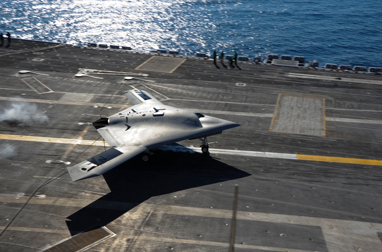 The experimental X-47B Unmanned Combat Air System Demonstrator conducts an arrested landing aboard the aircraft carrier USS Theodore Roosevelt at sea, Nov. 9, 2013. The USS Theodore Roosevelt is the third aircraft carrier to test the tailless, unmanned autonomous air craft's ability to integrate with carrier environment. U.S. Navy photo By Seaman Anthony N. Hilkowski