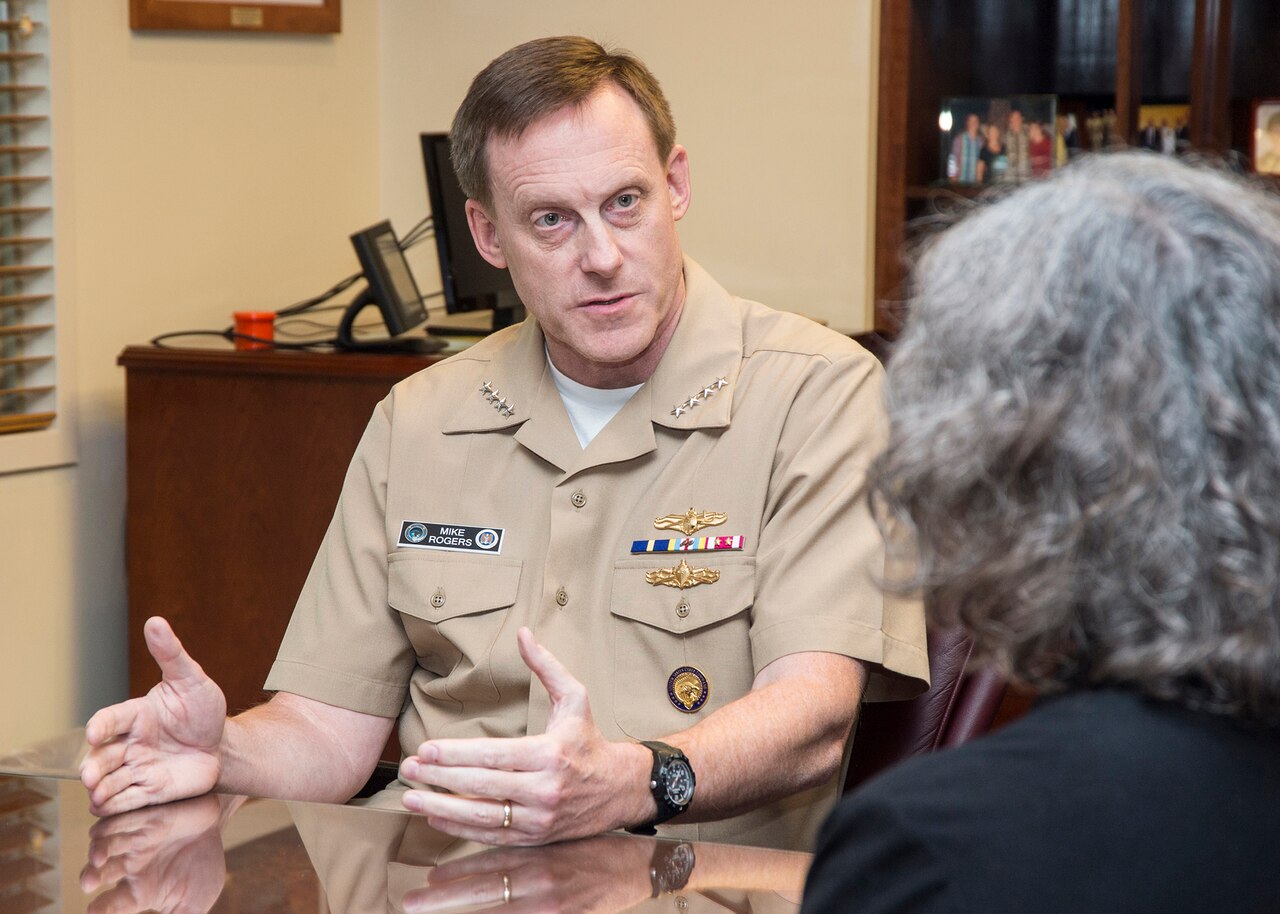Navy Adm. Mike Rogers, commander of U.S. Cyber Command and director of the National Security Agency, speaks with a DoD News reporter during an interview at the NSA headquarters building at Fort Meade, Md., Aug. 14, 2014. DoD photo