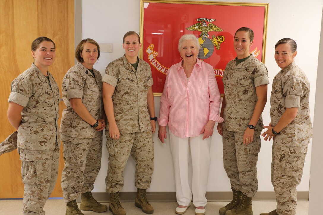 Eleanore Sonich, Marine Corps veteran, joins 1st Lt. Sarah Burns, public affairs officer, Marine Corps Base Camp Lejeune, North Carolina, Master Sgt. Carolyn Dukes, communications chief, Ground Combat Element Integrated Task Force; 1st Lt. Cristina Bailey, supply officer, GCEITF; 1st Lt. Stephanie Damren, combat engineer officer, GCEITF, and Lt. Col. Julie Nethercot, executive officer, GCEITF, during a visit to MCB Camp Lejeune, Aug. 11, 2014. Sonich was one of the first women to enlist the Marine Corps during the height of the second World War. (U.S. Marine Corps photo by Cpl. Paul S. Martinez/Released)