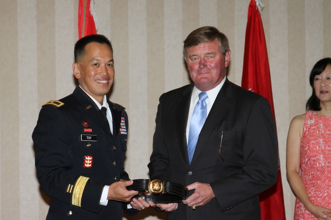 Retired Lt. Gen. Robert Flowers, 50th Chief of Engineers, presents Brig. Gen. Mark Toy, South Pacific Division commander, his general officer belt at a frocking ceremony in Cypress, Calif., Aug. 15.