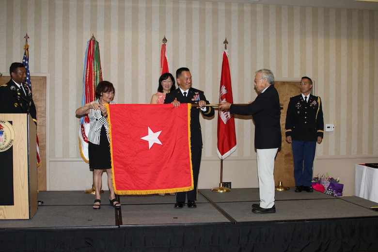 New Brig. Gen. Mark Toy, South Pacific Division commander, unfurls his general officer flag with family and friends at a frocking ceremony in Cypress, Calif., Aug. 15.