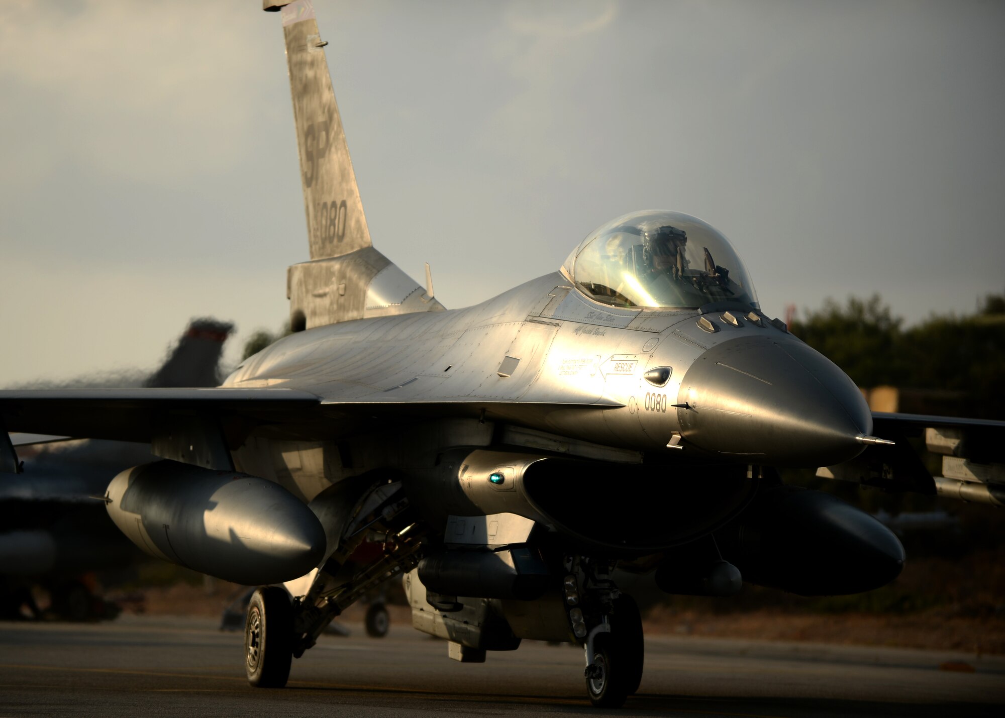 A U.S. Air Force F-16 Fighting Falcon fighter aircraft pilot taxis to the flightline Aug. 18, 2014, at Souda Bay, Greece, during a two-week training event between Greece and the U.S. The training allows the NATO partners to fly together during peacetime to strengthen their joint military capability. (U.S. Air Force photo by Staff Sgt. Daryl Knee/Released)