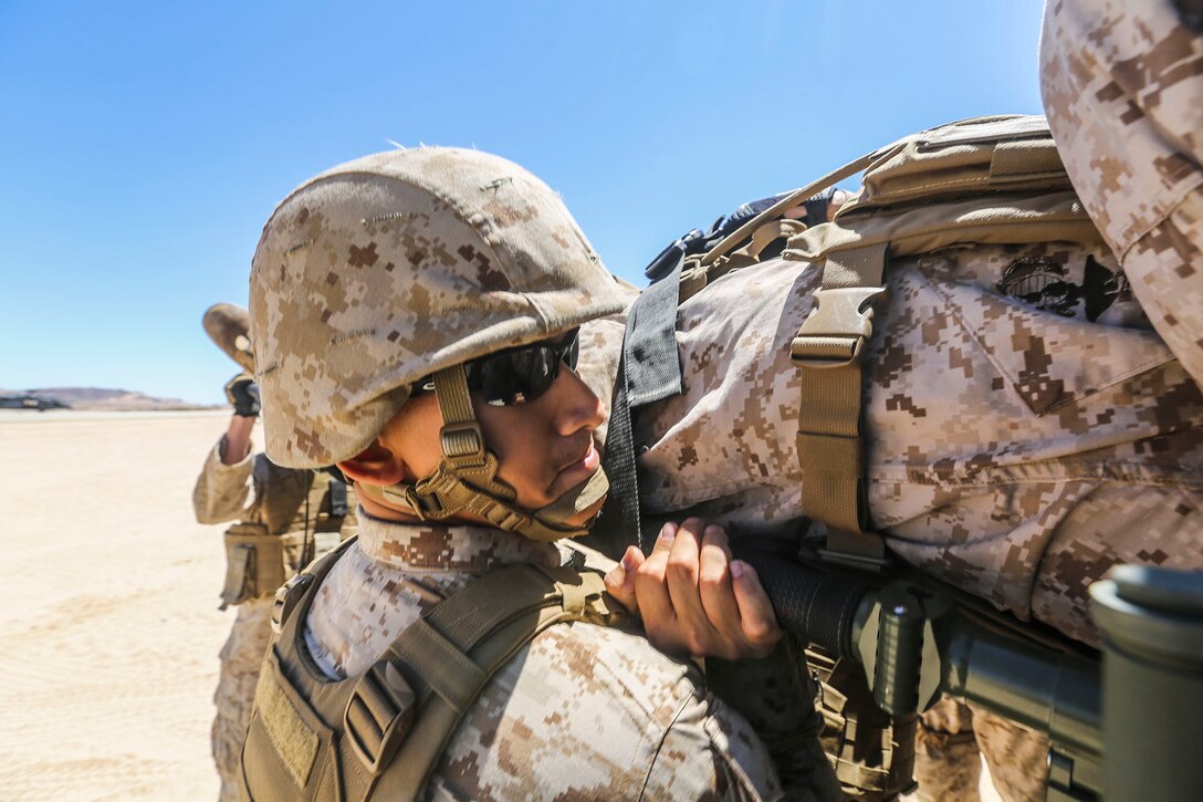 A corpsman with 1st Medical Battalion, 1st Marine Expeditionary Brigade, transports a simulated wounded Marine as part of a mock casualty evacuation at Marine Corps Air Ground Combat Center Twentynine Palms, Calif., Aug. 6, 2014. The casualty evacuation was part of Large Scale Exercise 2014, being conducted from Aug. 8-14. LSE-14 is a bilateral training exercise between the U.S. and Canada which includes live, simulated, and constructive operations to enhance both countries’ ability to activate and deploy a Marine Air Ground Task Force with speed and effectiveness in support of the full range of military operations as required by combatant commanders. (U.S. Marine Corps photo by Lance Cpl. Caitlin Bevel)