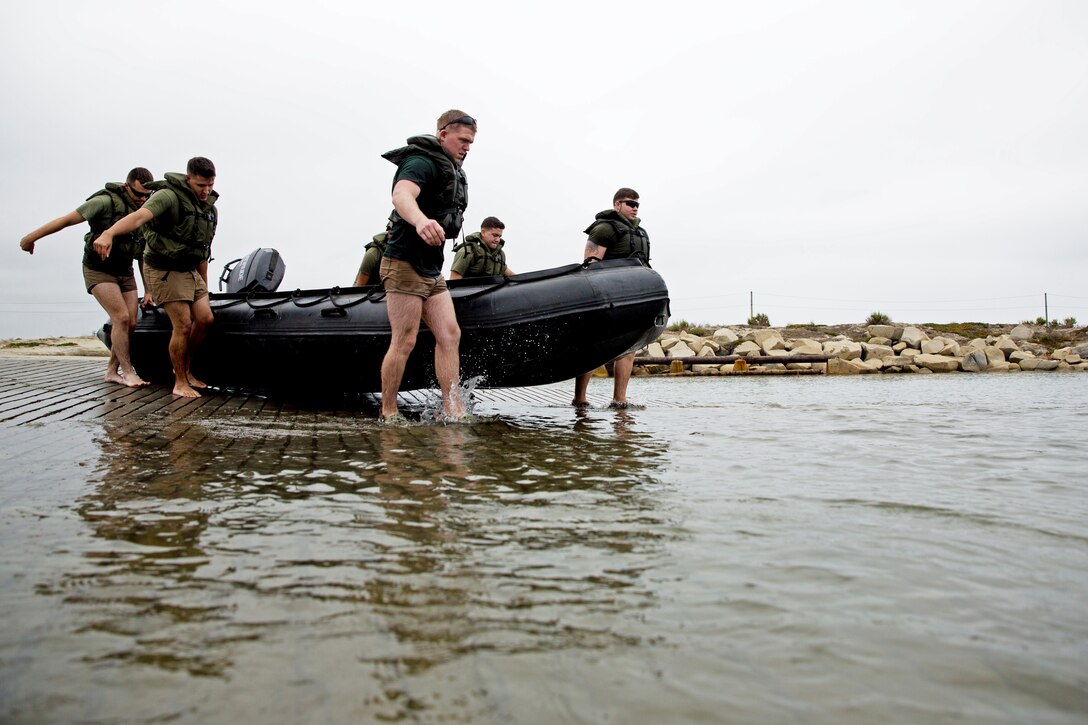 Marines with 2nd Intelligence Battalion, II Marine Expeditionary Force launch a Zodiac boat to conduct depth and terrain analysis off a beach at Camp Pendleton, Calif., July 15, 2014. More than a dozen Marines from the battalion conducted a weeklong training mission at the base to test their ability to carry out hydrographic surveys beyond their home station at Camp Lejeune, N.C. They recently pioneered the hydrographic survey program and traveled to Camp Pendleton as a test of their capabilities beyond their base of operations. The Marines teamed up with members of the Navy’s Naval Oceanography Special Warfare Command during the training as a way to collaborate and share lessons learned from their respective programs. Their successful deployment of a survey program to California helped prove their concept has the potential to reach out and support Marine units in various training and operational environments in the future. (U.S. Marine Corps photo by Sgt. Paul Peterson)