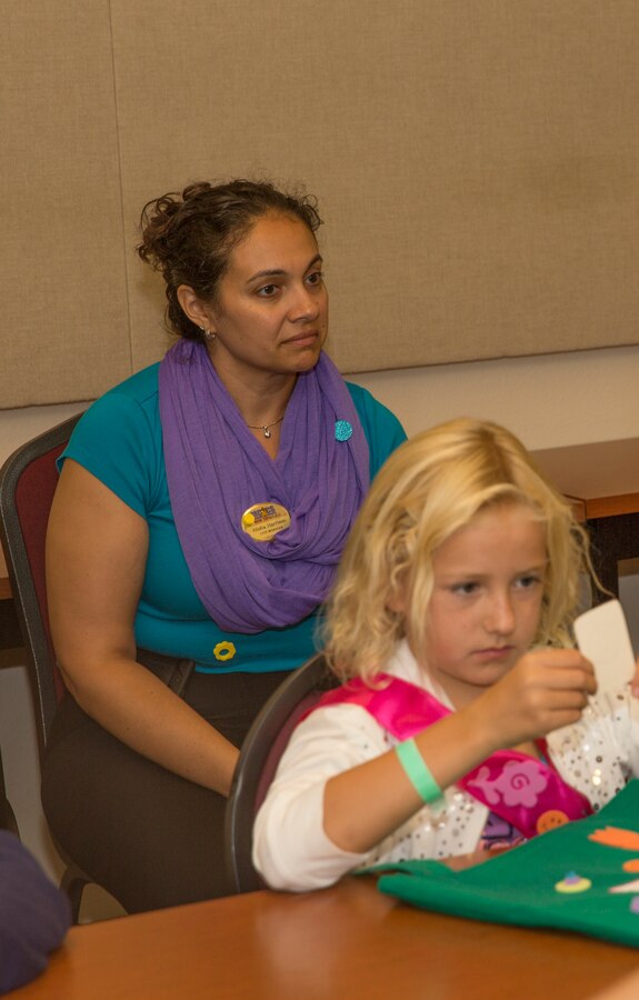 Alisha Harrison, Child, Youth and Teen Program manager with the center, watches a class during a Smart-Girl retreat in the Miramar Room at the Hub aboard Marine Corps Air Station Miramar, Calif., Aug. 16. The Smart-Girl program helps girls learn skills in communication, leadership, critical thinking, assertiveness and refusal, anti-bullying, healthy decision making and smart social media usage.