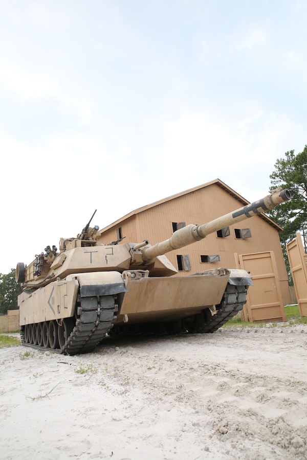 An M1A1 Abrams tank with 4th Tank Battalion takes a defensive position while conducting an assault on a simulated enemy town Aug. 17, 2014, aboard Camp Lejeune, N.C., during exercise Heavy Metal 14. The tanks maneuvered with infantry units to capture key locations throughout the city. 