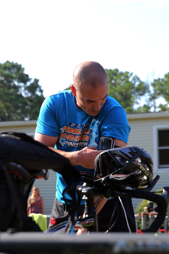 Master Sgt. Jeffery R. VanDuzer prepares for a 10-mile bike ride after finishing a 400-meter swim during Marine Corps Community Services' Sprint Triathlon/Relay at Marine Corps Air Station Cherry Point, N.C., Aug. 16, 2014. VanDuzer is the fuel chief with Headquarters and Headquarters Squadron and is a native of Seattle.