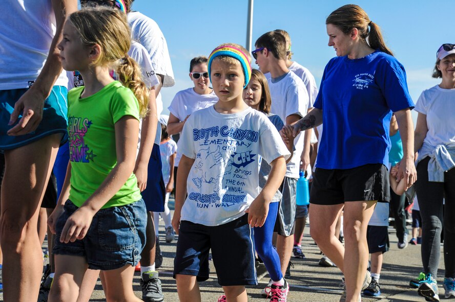Team Fairchild Airmen and families participate in a Color Run 5k at Fairchild Air Force Base, Washington, Aug. 16, 2014. The Color Run was meant to increase base awareness for the upcoming Air Force Ball being held at the Red Lion at the Park in Spokane, Washington, on Sept. 6, celebrating the Air Force’s 67th birthday. (U.S. Air Force photo by Airman 1st Class Janelle Patiño/Released)