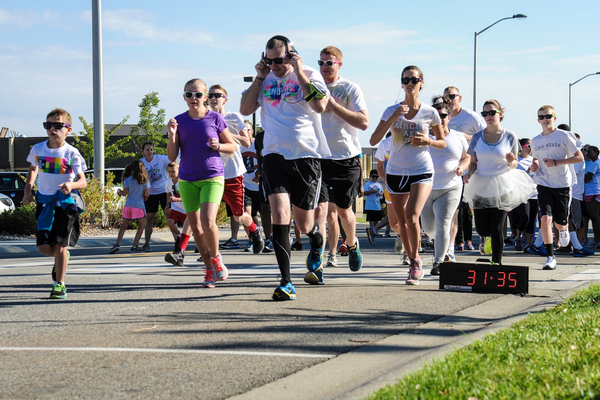 Team Fairchild Airmen and families participate in a Color Run 5k at Fairchild Air Force Base, Washington, Aug. 16, 2014. The Color Run was meant to increase base awareness for the upcoming Air Force Ball being held at the Red Lion at the Park in Spokane, Washington, on Sept. 6, celebrating the Air Force’s 67th birthday. (U.S. Air Force photo by Airman 1st Class Janelle Patiño/Released)