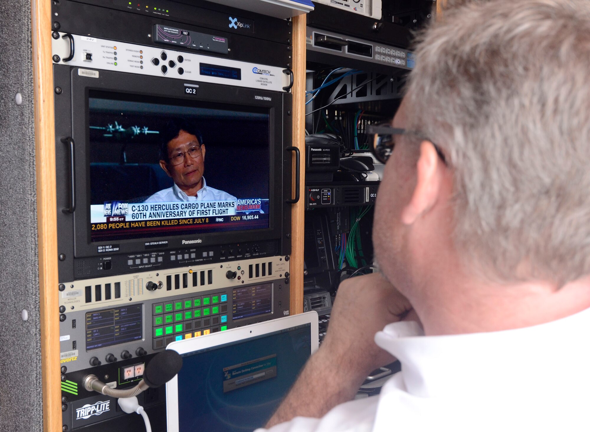 A Fox News Channel producer broadcasts live from the Dobbins Air Reserve Base airfield Aug. 19, 2014 in recognition of the 60th Anniversary of the C-130 aircraft. The segment featured Mr. Tim Nguyen, an aviator in the Vietnamese Air Force, and one of the final passengers to board a U.S. Air Force C-130 on what would be the final flight out of Vietnam. (U.S. Air Force photo/Don Peek)
