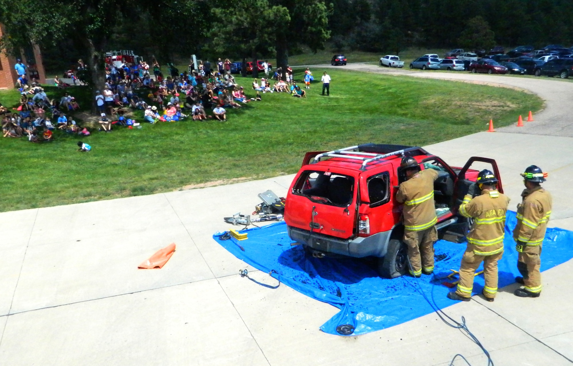 Firefighters from the 10th Civil Engineer Squadron fire department provide  a vehicle extrication demonstration during an open house Aug. 16. (U.S. Air Force photo/Mike Mater)