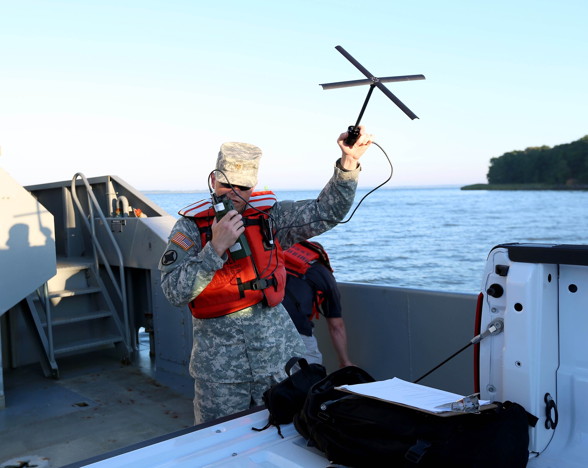 U.S. Army Maj. John Burns, Joint Task Force Civil Support daily operations watch officer, conducts a radio check on a satellite communications radio onboard U.S. Army Vessel Hobkirk during a Joint Logistics Over-the-Shore exercise at Fort Eustis, Va., Aug. 14, 2014. The exercise evaluated how equipment and supplies are moved ashore when port facilities are nonexistent, damaged or too primitive for ships to off-load their cargo at a pier. (Department of Defense photo by U.S. Navy Petty Officer 1st Class Brian Dietrick/Released)