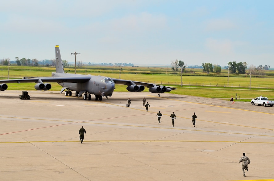 Aircrew members run to their aircraft during a minimum-interval takeoff exercise on Minot Air Force Base, N.D., Aug. 15, 2014. Exercises like these are integral to maintaining mission readiness. (U.S. Air Force photo/Senior Airman Brittany Y. Bateman) 