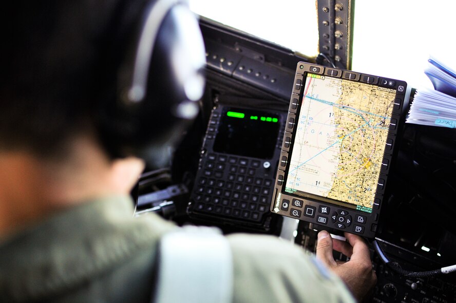 U.S. Air Force 1st Lt. Bradley E. Emmett II, a C-130 pilot with the 169th Airlift Squadron, uses the Real Time in Cockpit device aboard his C-130H3 Hercules while en route to the Peoria, Ill., Aug. 16, 2014. The RTIC enhances C-130 aircrews’ ability to communicate with ground crews and other aircraft during airlift and airdrop operations, according to the Northrop Grumman Systems Corporation.  This new capability can increase situational awareness by providing aircrews a real-time tactical picture within their area of operations. (U.S. Air National Guard photo by Staff Sgt. Lealan Buehrer/Released)