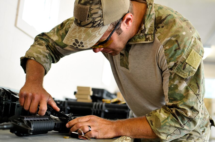 U.S. Air Force Master Sgt. John M. Oliver, a tactical air control party specialist with the 169th Air Support Operations Squadron, makes an adjustment on his M4 carbine before a weapons qualification at Operation Northern Strike in Alpena, Mich., Aug. 15, 2014. Northern Strike was a 3-week-long exercise led by the National Guard that demonstrated the combined power of joint and multinational air and ground forces. TACPs with the Air National Guard’s 169th ASOS from Peoria, Ill., and more than 5,000 other armed forces members from 12 states and two coalition nations participated in the combat training. (U.S. Air National Guard photo by Staff Sgt. Lealan Buehrer/Released)