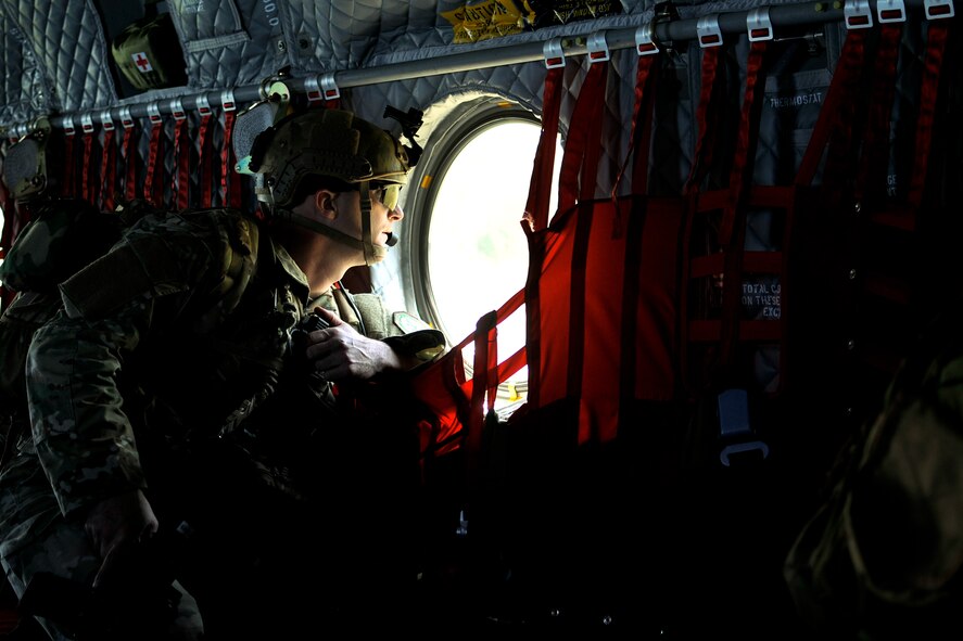 U.S. Air Force Staff Sgt. Nathan M. Adams, a tactical air control party specialist with the 169th Air Support Operations Squadron, searches for enemy forces and strongholds as a CH-47 Chinook carrying TACP units circles a landing zone at Operation Northern Strike in Grayling Air Gunnery Range, Grayling, Mich., Aug. 14, 2014. Northern Strike was a 3-week-long exercise led by the National Guard that demonstrated the combined power of joint and multinational air and ground forces. TACPs with the Air National Guard’s 169th ASOS from Peoria, Ill., and more than 5,000 other armed forces members from 12 states and two coalition nations participated in the combat training. (U.S. Air National Guard photo by Staff Sgt. Lealan Buehrer/Released)