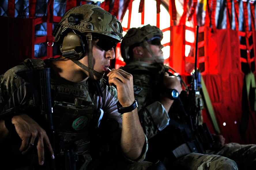 U.S. Air Force Senior Airman Thomas Vamvakos, a tactical air control party specialist with the 169th Air Support Operations Squadron, enjoys a celebratory sucker in a CH-47 Chinook after a successful reconnaissance mission at Operation Northern Strike in Grayling Air Gunnery Range, Grayling, Mich., Aug. 14, 2014. Northern Strike was a 3-week-long exercise led by the National Guard that demonstrated the combined power of joint and multinational air and ground forces. TACPs with the Air National Guard’s 169th ASOS from Peoria, Ill., and more than 5,000 other armed forces members from 12 states and two coalition nations participated in the combat training. (U.S. Air National Guard photo by Staff Sgt. Lealan Buehrer/Released)