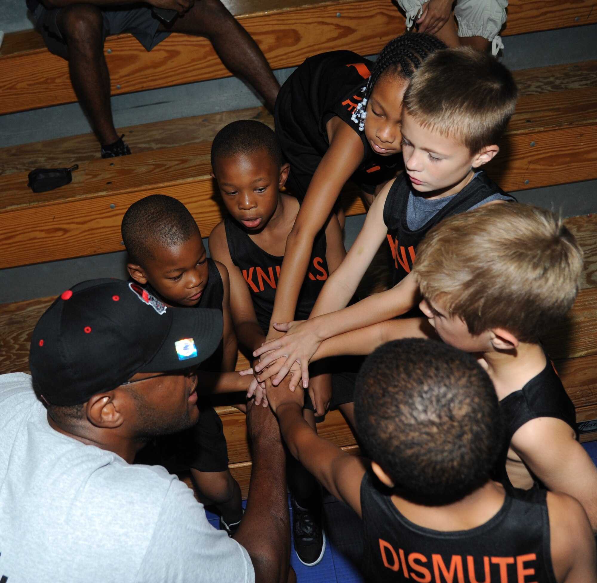 Tech. Sgt. Ternae Riley, 81st Communications Squadron and the “Knicks” coach, speaks to his team following a youth basketball game Aug. 16, 2014, at the Youth Center, Keesler Air Force Base, Miss.  This was a friendly game between the 76ers and the Knicks five-to-seven year old teams. (U.S. Air Force photo by Kemberly Groue)