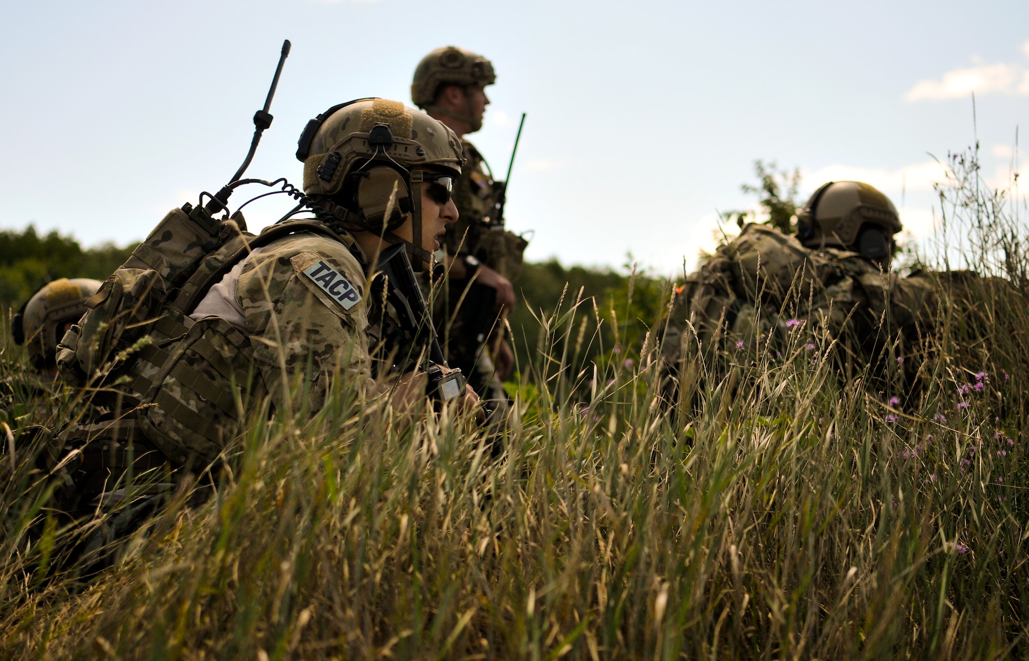Tactical air control party specialists with the 169th Air Support Operations Squadron survey an enemy-controlled landing zone before calling in close-air support at Operation Northern Strike in Grayling Air Gunnery Range, Grayling, Mich., Aug. 14, 2014. Northern Strike was a 3-week-long exercise led by the National Guard that demonstrated the combined power of joint and multinational air and ground forces. TACPs with the Air National Guard’s 169th ASOS from Peoria, Ill., and more than 5,000 other armed forces members from 12 states and two coalition nations participated in the combat training. (U.S. Air National Guard photo by Staff Sgt. Lealan Buehrer/Released)