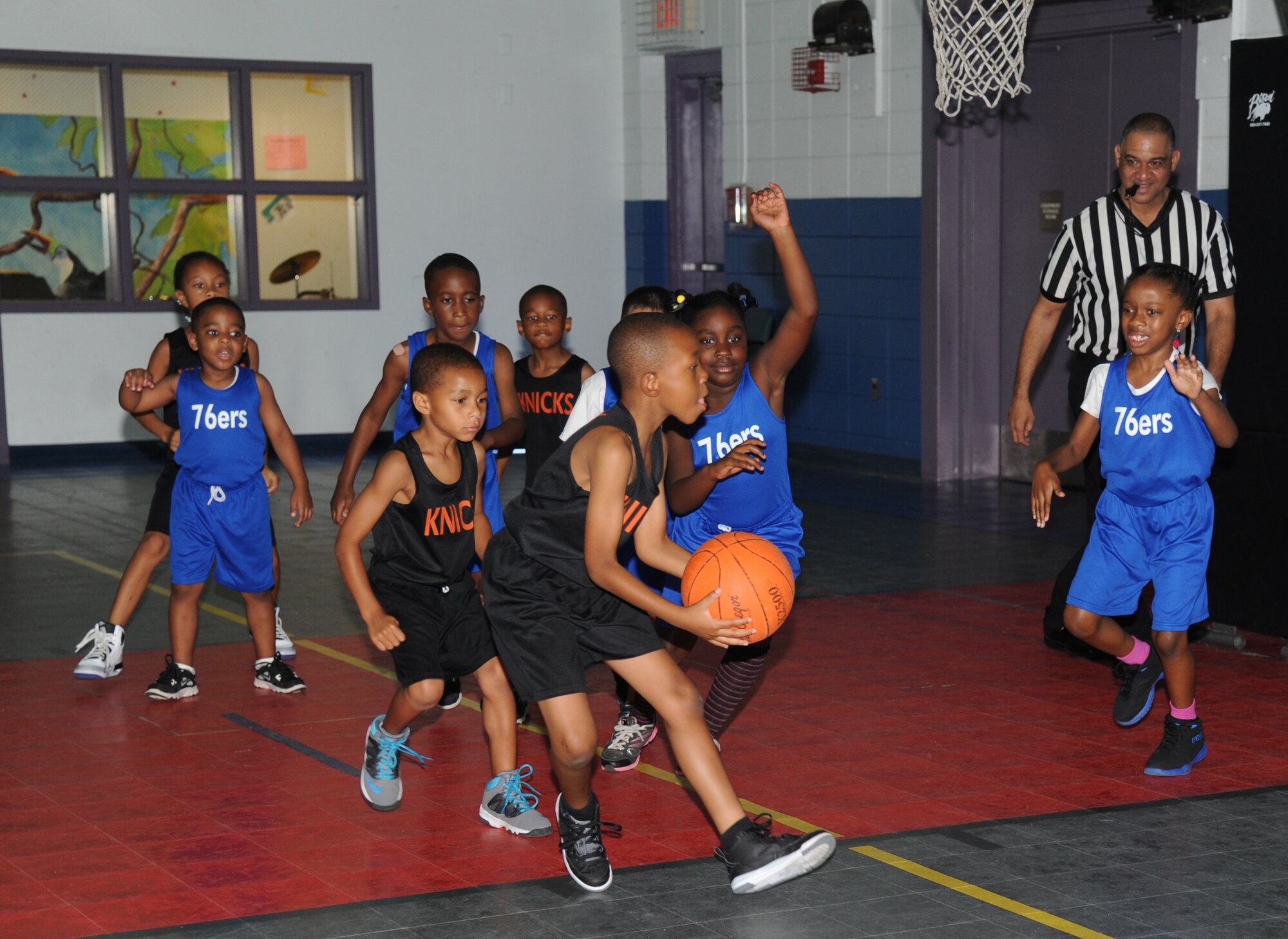 The son of Tech. Sgt. Shaquanna Riley, 336th Training Squadron, and Tech. Sgt. Ternae Riley, 81st Communications Squadron, prepares to shoot the ball during a youth basketball game Aug. 16, 2014, at the Youth Center, Keesler Air Force Base, Miss.  This was a friendly game between the 76ers and the Knicks five-to-seven year old teams. (U.S. Air Force photo by Kemberly Groue)