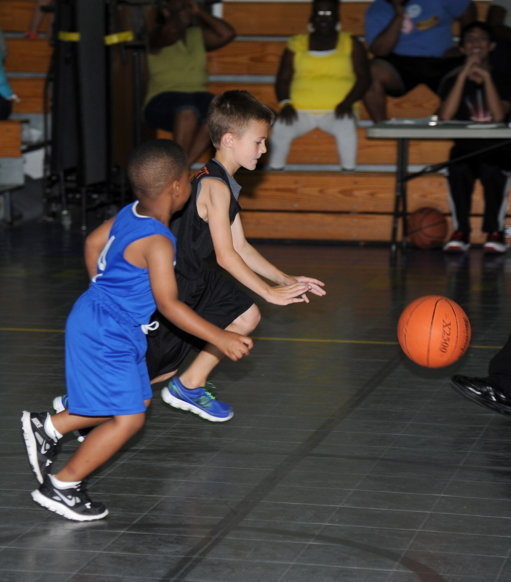 The son of Senior Master Sgt.  Jason Holbert, 81st Communications Squadron, drives the ball down the court as the son of Senior Airman Michael Mitchell, 916th CS, Seymour Johnson Air Force Base, N.C., defends during a youth basketball game Aug. 16, 2014, at the Youth Center, Keesler Air Force Base, Miss.  This was a friendly game between the 76ers and the Knicks five-to-seven year old teams. (U.S. Air Force photo by Kemberly Groue)