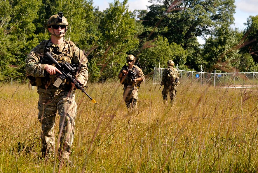 From left, U.S. Air Force Staff Sgt. Nathan M. Adams, Senior Airman Thomas Vamvakos and Senior Airman Lance A. Liggett, tactical air control party specialists with the 169th Air Support Operations Squadron, patrol during a reconnaissance mission at Operation Northern Strike in Grayling Air Gunnery Range, Grayling, Mich., Aug. 14, 2014. Northern Strike was a 3-week-long exercise led by the National Guard that demonstrated the combined power of joint and multinational air and ground forces. TACPs with the Air National Guard’s 169th ASOS from Peoria, Ill., and more than 5,000 other armed forces members from 12 states and two coalition nations participated in the combat training. (U.S. Air National Guard photo by Staff Sgt. Lealan Buehrer/Released)