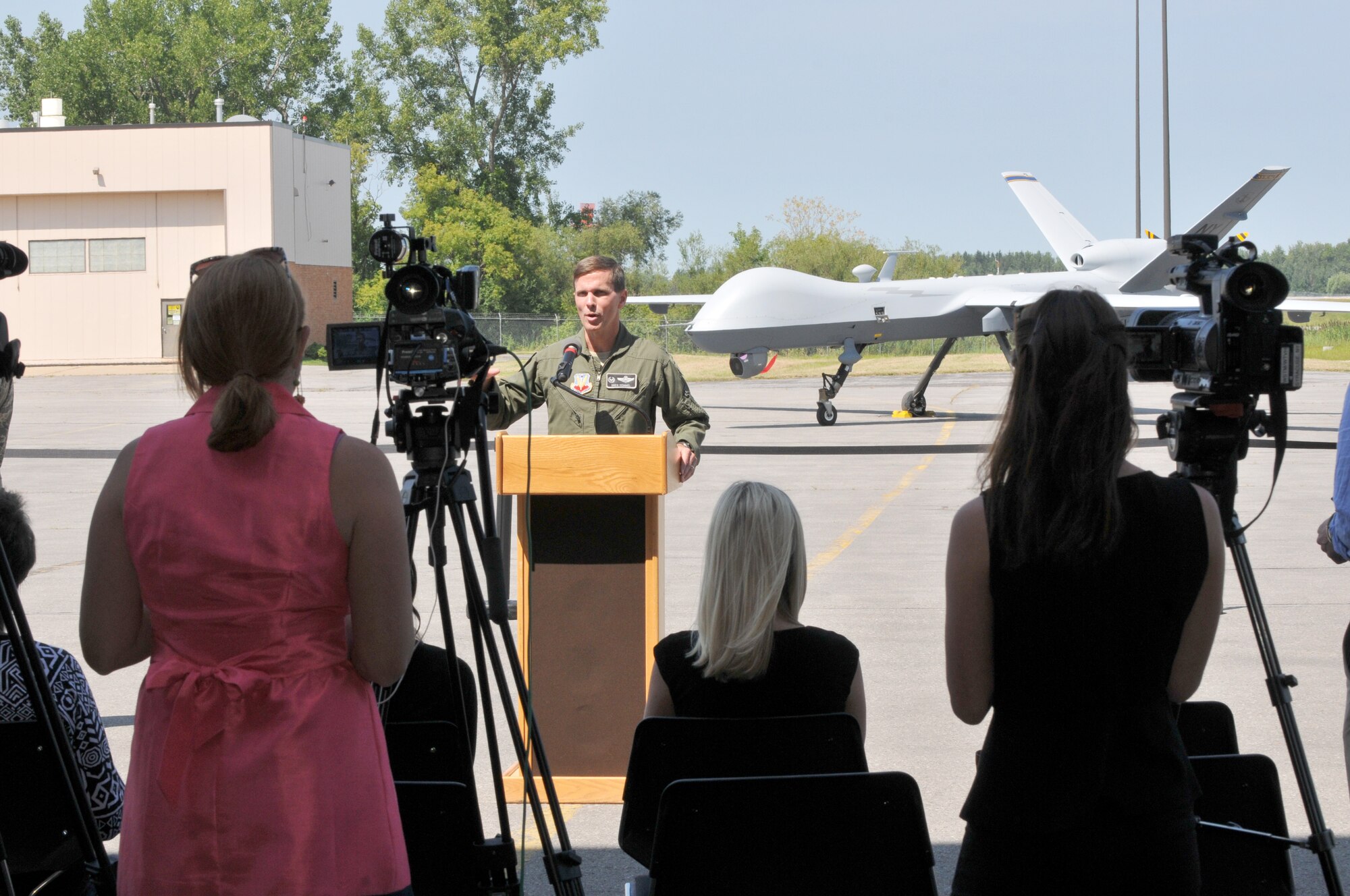 New York Air National Guard Col. Greg Semmel, commander of the 174th Attack Wing (ATKW) speaks to the media at Hancock Field Air National Guard Base in Syracuse NY on 19 August 2014.  Semmel was speaking about the future of MQ-9 operations at Hancock Field.  During the event the media was able to witness the first Taxi of an MQ-9 at Hancock Field.  (New York Air National Guard photo by Tech. Sgt. Jeremy M. Call)