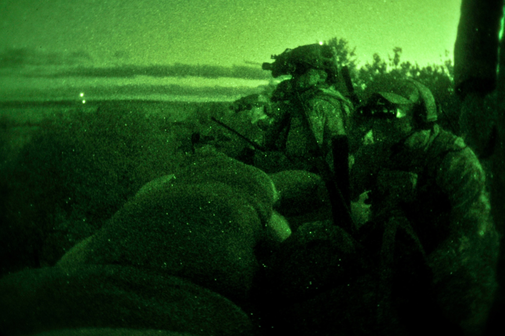 Tactical air control party specialists with the 169th Air Support Operations Squadron watch for air support on the Grayling Air Gunnery Range during evening operations at Operation Northern Strike in Grayling, Mich., Aug. 13, 2014. Northern Strike was a 3-week-long exercise led by the National Guard that demonstrated the combined power of joint and multinational air and ground forces. TACPs with the Air National Guard’s 169th ASOS from Peoria, Ill., and more than 5,000 other armed forces members from 12 states and two coalition nations participated in the combat training. (U.S. Air National Guard photo by Staff Sgt. Lealan Buehrer/Released)