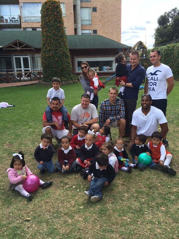 Maj. Adam Dalson, Capt. Jared Thomas, Capt. Ryan Sullivan, Capt. Kenneth Welborn, Staff Sgt. Stephen Williams, Senior Airman Laura Reed and Senior Airman Andy Lopez pose for a photo with orphans from La Casa de la Madre y El Nino while on their off time during a U.S. Southern Command Capstone mission. The aircrew donated supplies and toys to the orphanage and spent hours playing with and caring for the children. (Courtesy photo by Maj. Adam Dalson)