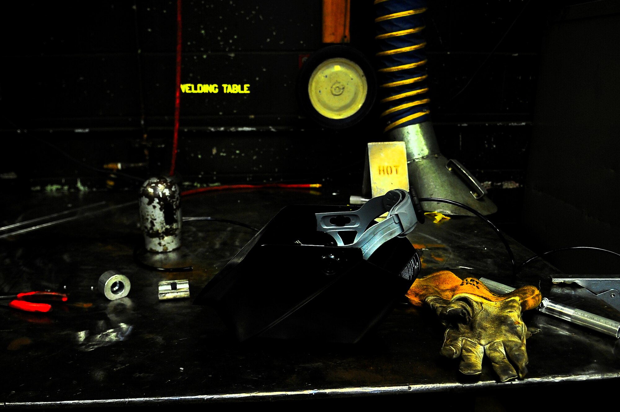 A metals technician’s gear sits on a welding table on Minot Air Force Base, N.D., Aug. 7, 2014. Metals technicians from the 5th MXS uses a lathe, drill press, torch and imagination to repair, and at times create parts that are no longer available. (U.S. Air Force photo/Senior Airman Brittany Y. Bateman)