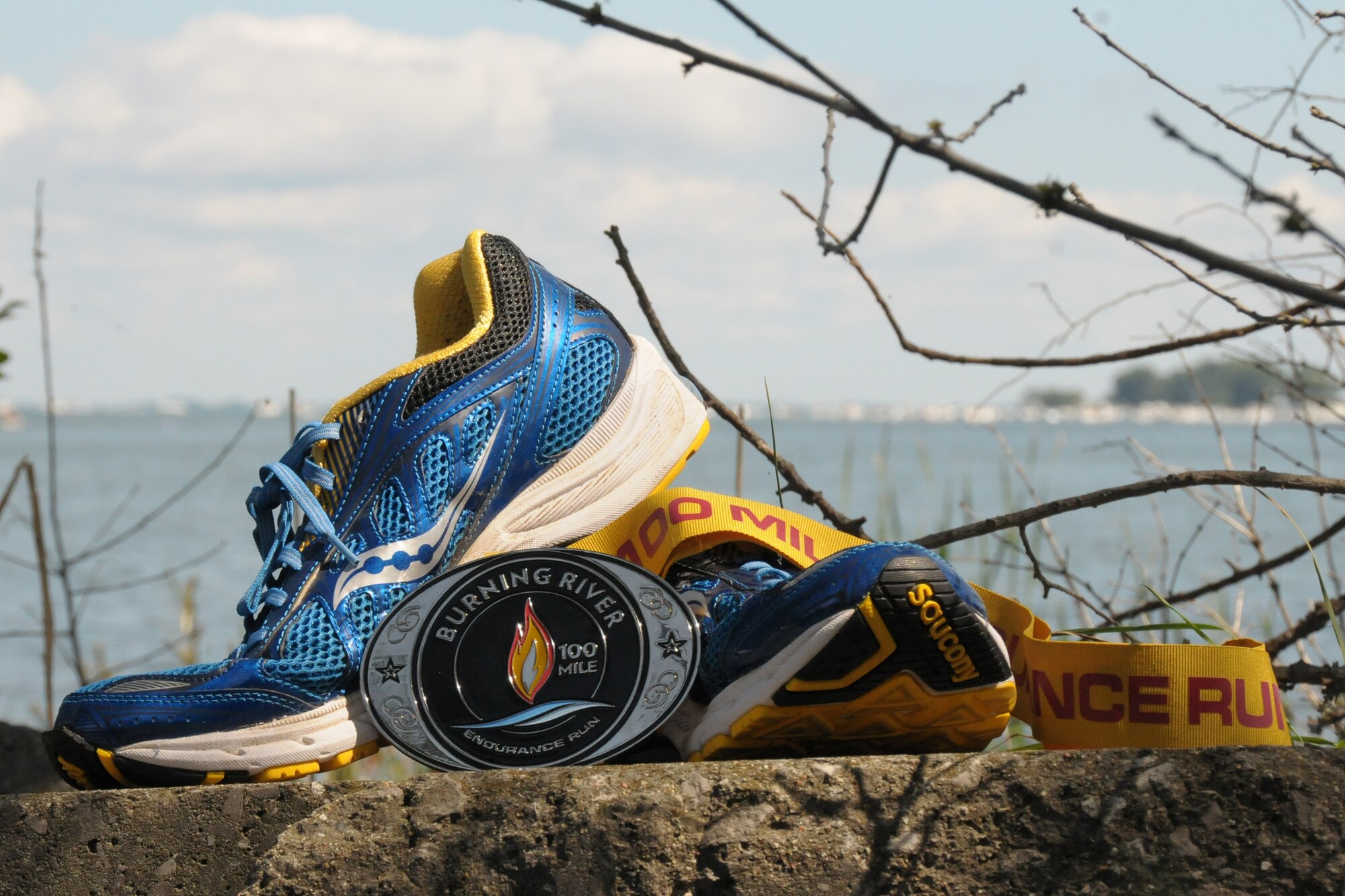 Staff Sgt. Lukas Fisher, an Airman with the 127th Wing Inspector General office, completed the Burning River 100-mile Endurance Run on August 2-3, 2014. Pictured are his running shoes and medal he was awarded for completing the 100 mile trek on foot. (U.S. Air National Guard Photo by SSgt. Samara Taylor)