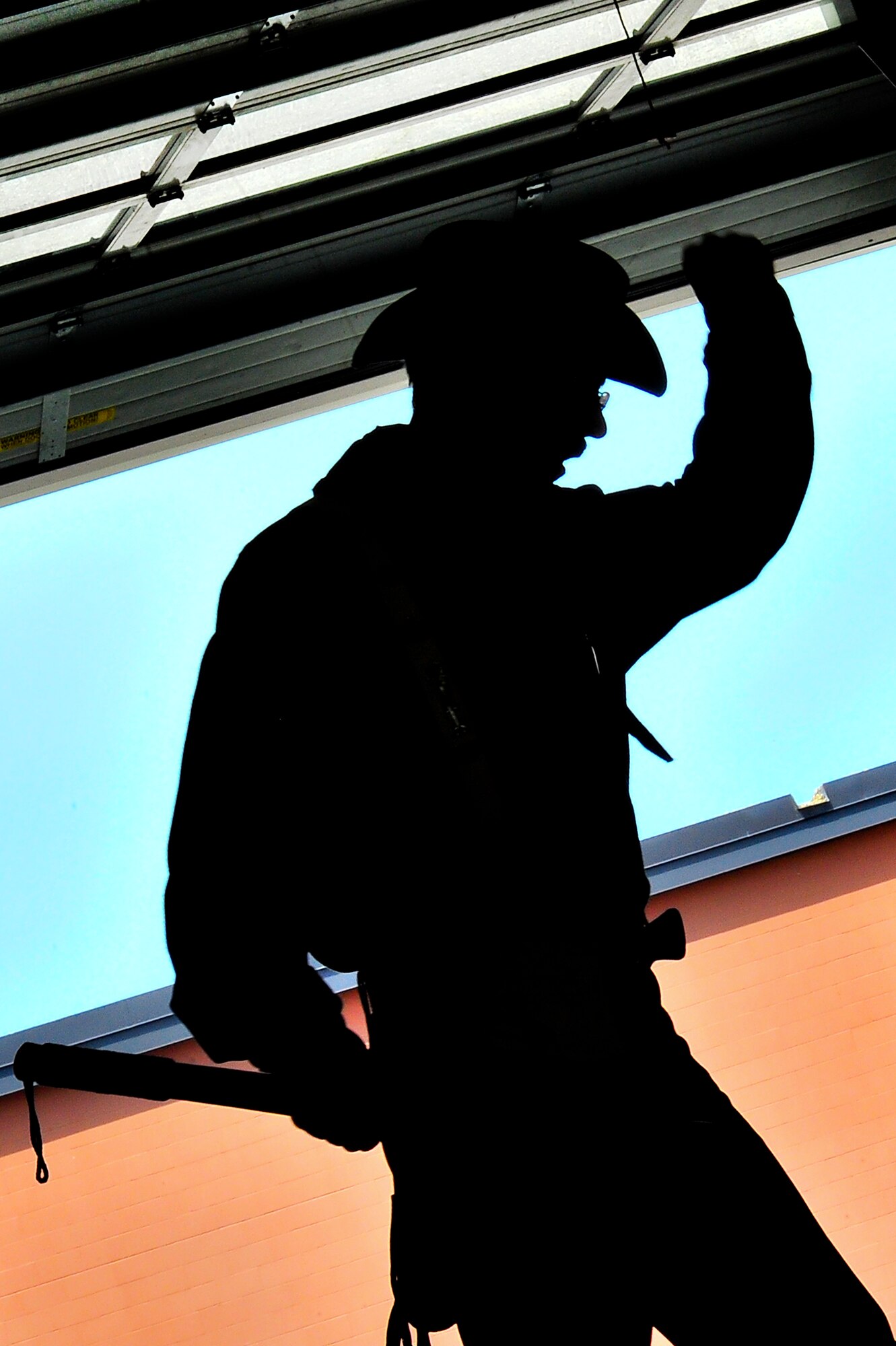 Retired Air Force Master Sgt. David Larrison, 91st Missile Wing mascot Teddy Roosevelt, chants during the 91st MW Global Strike Challenge kick-off party on Minot Air Force Base, N.D., Aug. 15, 2014. Global Strike Challenge events provide teams the opportunity to improve their knowledge, readiness and effectiveness through intense preparation and spirited competition. (U.S. Air Force photo/Senior Airman Brittany Y. Bateman)