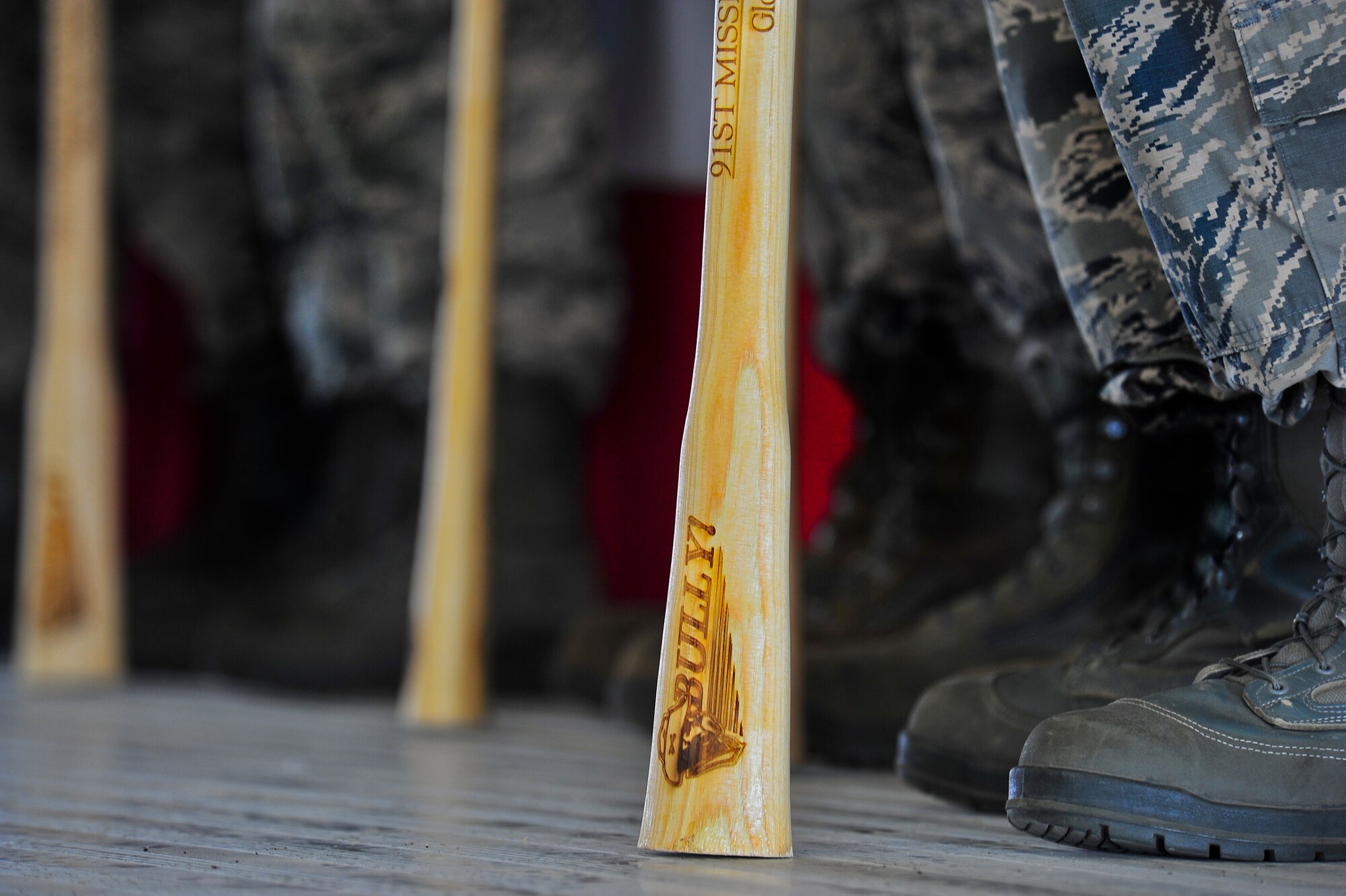 Members of the 91st Missile Wing Global Strike Challenge team stand on stage with their bully sticks during the kick-off party on Minot Air Force Base, N.D., Aug. 15, 2014. Competition categories include bomber, Intercontinental Ballistic Missile and helicopter operations, bomber and ICBM maintenance and security forces. (U.S. Air Force photo/ Senior Airman Brittany Y. Bateman)