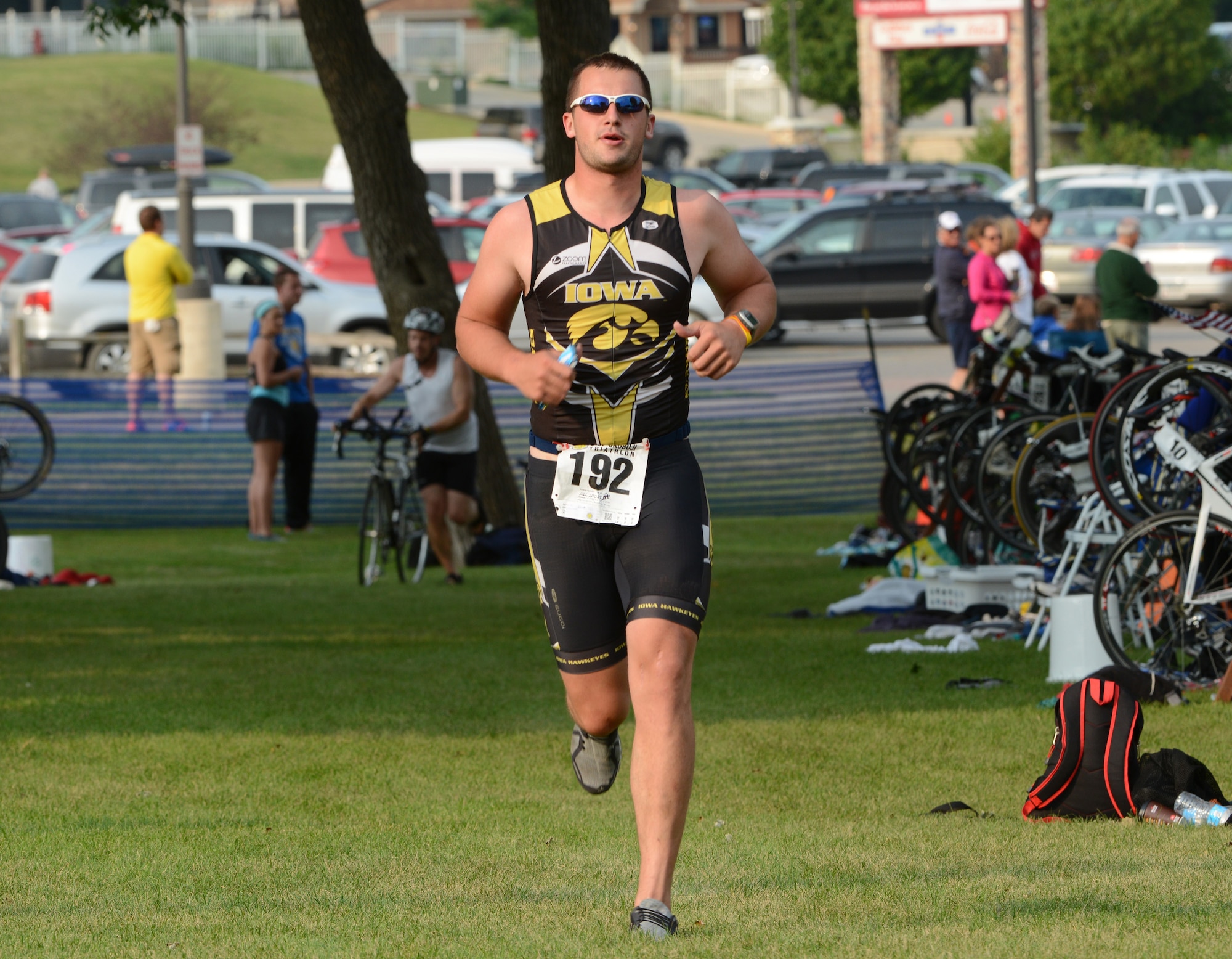 Emerging from the bicycle transition area wearing the black and gold of the University of Iowa Hawkeyes’, Senior Airman Michael Considine begins the third and final leg of the University of Okoboji Triathlon in Okoboji, Iowa on July 19, 2014. Considine is a member of the Iowa Air National Guard in Sioux City, IA and is also a full time student. As an avid triathlete, Considine competes individually and as a member of the University of Iowa Triathlon team. (U.S. Air National Guard photo by Master Sgt. Vincent De Groot/Released)