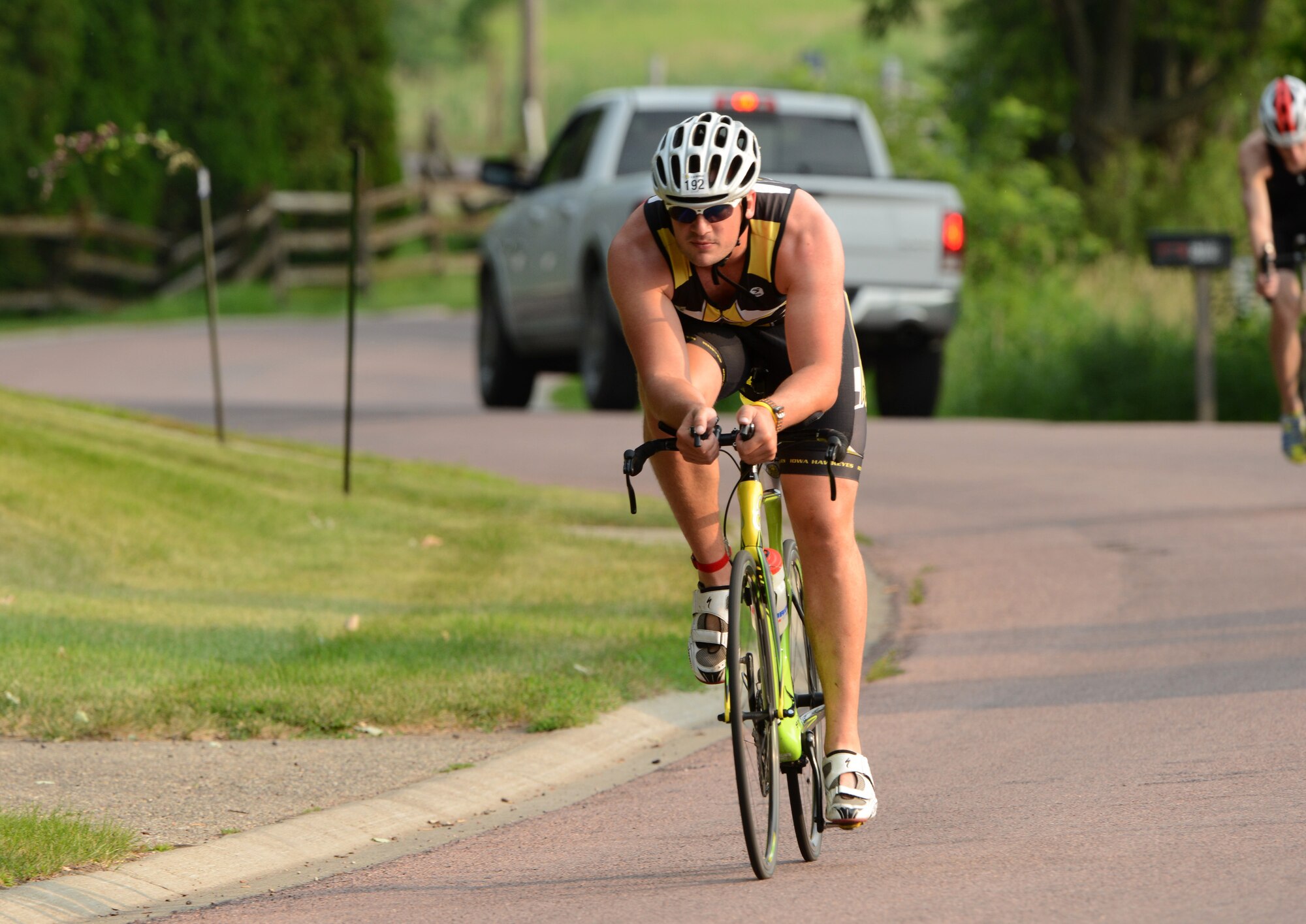 Senior Airman Michael Considine powers through the curves around West Lake, during the second leg of the University of Okoboji Triathlon in Okoboji, Iowa on July 19, 2014. Considine is a member of the Iowa Air National Guard in Sioux City, IA and is also a full time student. As an avid triathlete, Considine competes individually and as a member of the University of Iowa Triathlon team. (U.S. Air National Guard photo by Master Sgt. Vincent De Groot/Released)