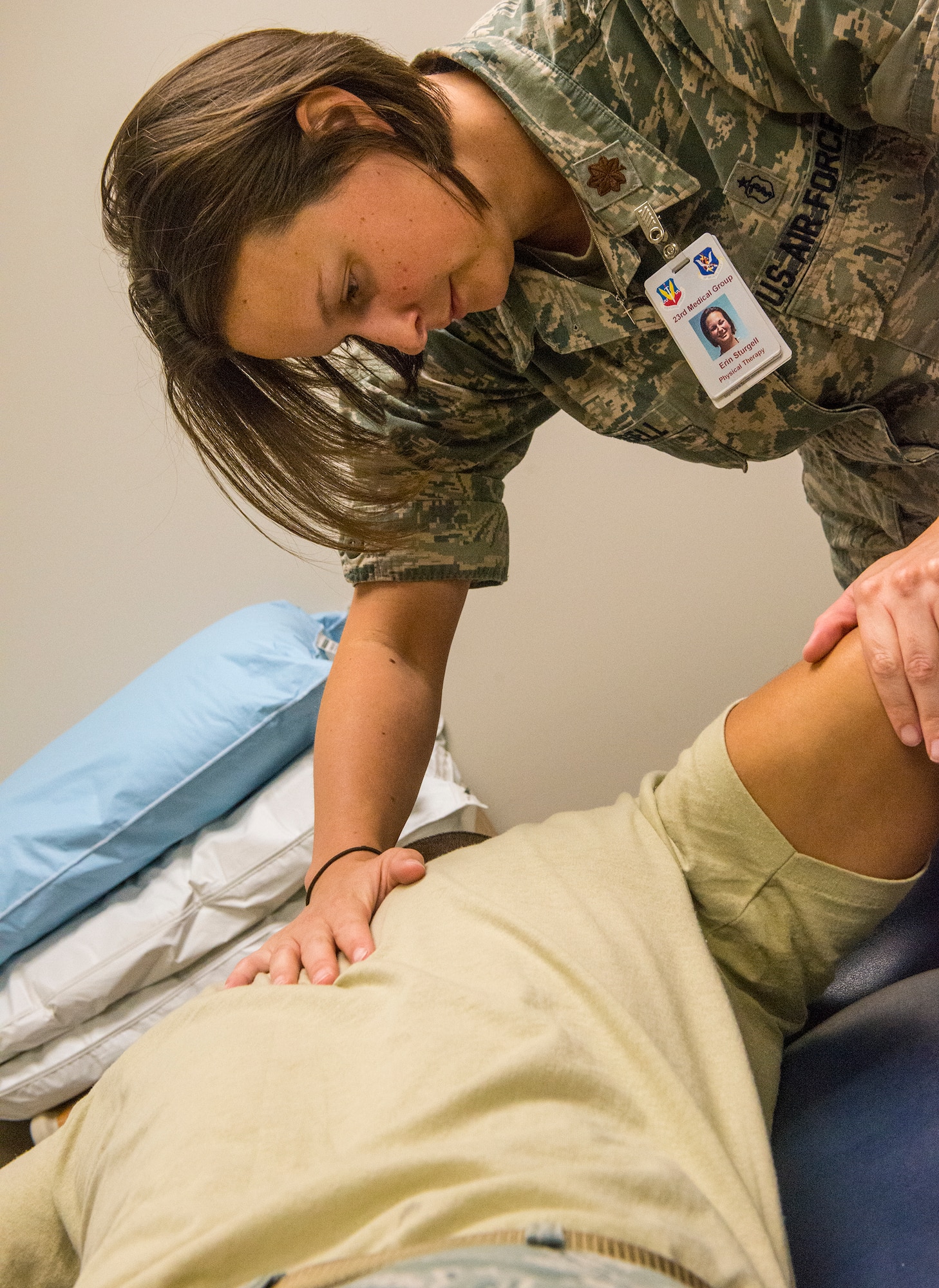 U.S. Air Force Maj. (Dr.) Erin Sturgell, 23d Medical Operations Squadron clinical medicine flight commander, pushes on the arm of a patient with a shoulder injury in the 23d MDOS physical therapy clinic at Moody Air Force Base, Ga., Aug. 19, 2014. Sturgell tested the patients shoulder for strength, stability and muscle control. The physical therapy clinic offers a walk-in Acute Clinic every Wednesday for Airmen who have an injury less than three-weeks old. (U.S. Air Force photo by Airman 1st Class Ceaira Tinsley/Released)