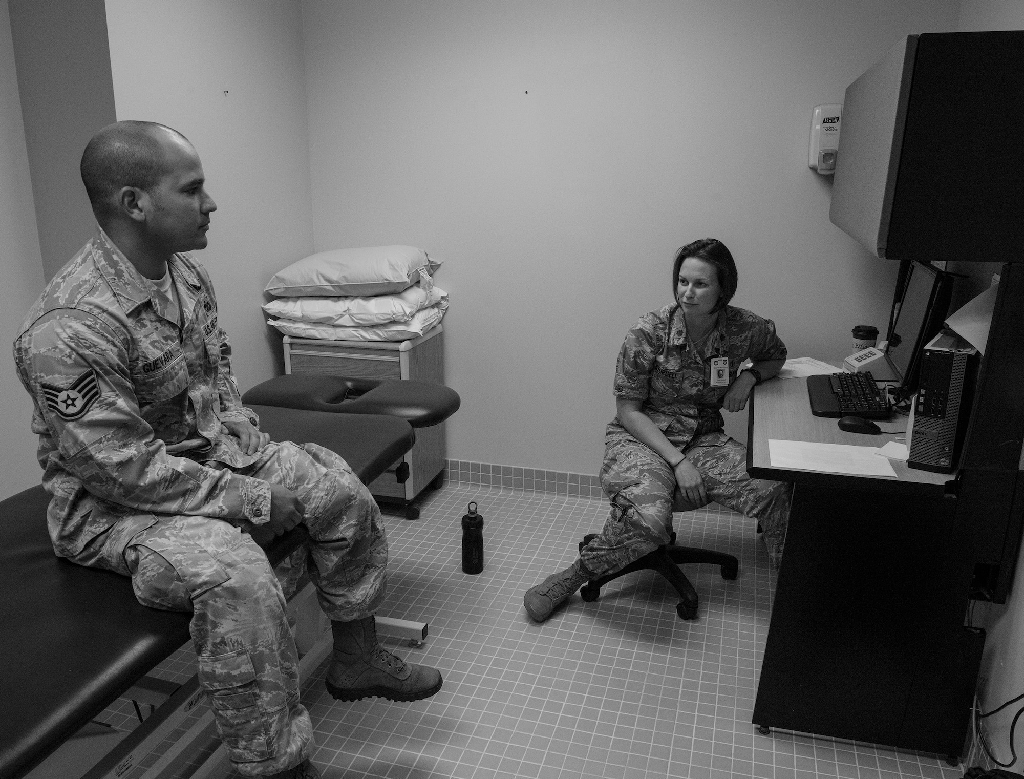 U.S. Air Force Maj. (Dr.) Erin Sturgell, 23d Medical Operations Squadron clinical medicine flight commander, conducts a consultation for Staff Sgt. Anthony Guevara, 820th Combat Operations Squadron vehicle equipment maintenance technician, during his final visit in the 23d MDOS physical therapy clinic at Moody Air Force Base, Ga., Aug. 19, 2014. Sturgell offered Guevara medical advice on weightlifting safety techniques and how muscle fatigue leads to injuries. The physical therapy clinic offers a special program for pararesumen and explosive ordnance disposal members called Fast Track, requiring them to be seen 24-72 hours after injury. (U.S. Air Force photo by Airman 1st Class Ceaira Tinsley/Released)