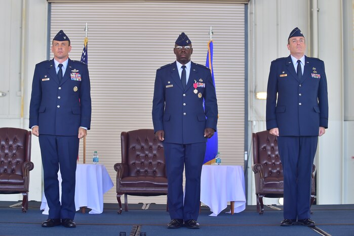 (Left to right) Colonel John Lamontagne, 437th Airlift Wing commander, Col. Dennis Dabney, 437th Maintenance Group outgoing commander, and Col. Brian Peters, 437th MXG incoming commander, stand at attention before command is transferred Aug. 15, 2014, at Joint Base Charleston, S.C. Dabney relinquished command of the group to Peters, whose previous position was as 436th Maintenance Operations Group deputy commander, Dover Air Force Base, Del. (U.S. Air Force photo/Senior Airman George Goslin)