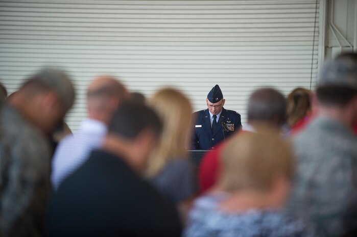Chaplain Ryan Ayers, 628th Air Base Wing, gives the invocation during the 437th Maintenance Group Change of Command Aug. 15, 2014, at Joint Base Charleston, S.C. Col. Dennis Dabney relinquished command of the group to Col. Brian Peters, whose previous position was as 436th Maintenance Operations Group deputy commander, Dover Air Force Base, Del. (U.S. Air Force photo/Senior Airman George Goslin)