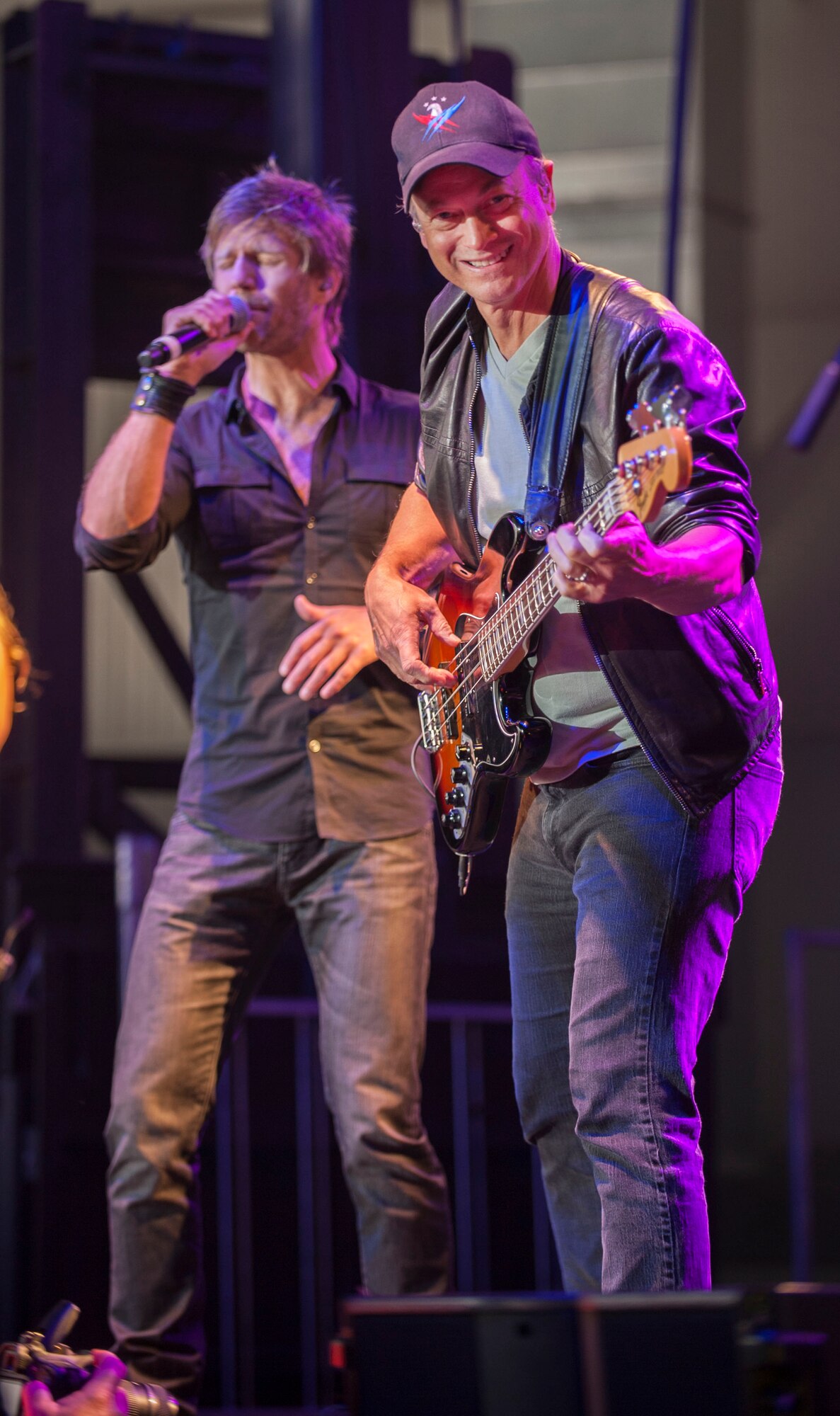 Gary Sinise and Jeff Vezain of the Lt. Dan Band perform on Minot Air Force Base, N.D., Aug. 16, 2014. The band plays around 50 shows a year for active duty military members, veterans and their families on military installations around the world. (U.S. Air Force photo/Airman 1st Class Apryl Hall)