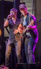 Gary Sinise and Jeff Vezain of the Lt. Dan Band perform on Minot Air Force Base, N.D., Aug. 16, 2014. The band plays around 50 shows a year for active duty military members, veterans and their families on military installations around the world. (U.S. Air Force photo/Airman 1st Class Apryl Hall)