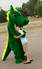 A child hugs 5th Force Support Squadron mascot Darcy the Dragon during the Annual Summer Block Party on Minot Air Force Base, N.D., Aug. 16, 2014. The event is held annually as a way to wrap up the summer season. (U.S. Air Force photo/Airman 1st Class Apryl Hall)