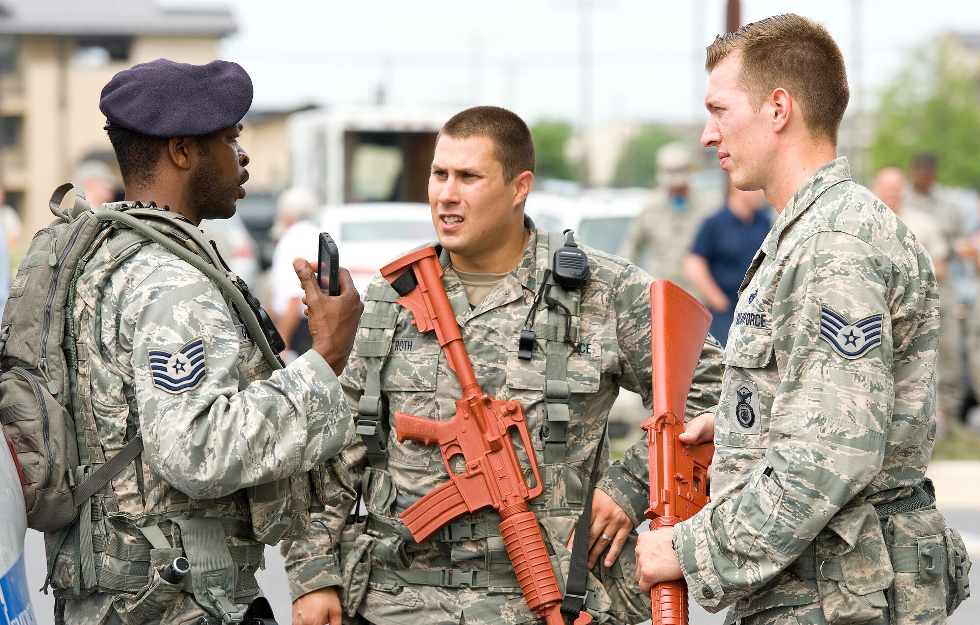 Tech. Sgt. Brian Goring, left, talks to Staff Sgts. Michael Roth, center, and Brian Lecates, right, all from the 436th Security Forces Squadron, during an active shooter exercise Aug. 1, 2014, at Dover Air Force Base, Del. Goring was the on-scene SFS commander coordinating the neutralization of the active shooter, building sweep and rescuing of hostages. Roth and Lecates led numerous hostages from the building to safety during the exercise. (U.S. Air Force photo/Roland Balik)